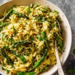 Delicious Asparagus Orzo dish garnished with herbs and served in a bowl