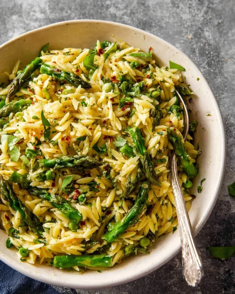 Delicious Asparagus Orzo dish garnished with herbs and served in a bowl