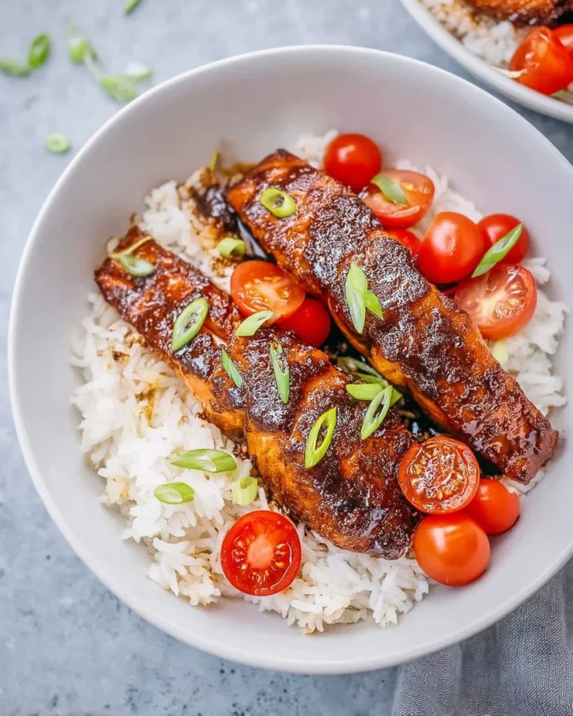 Delicious balsamic glazed salmon served on a plate with garnish.