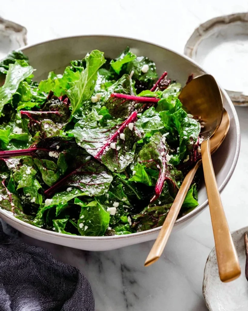 Colorful and fresh beet green salad featuring vibrant greens and roasted beet slices.