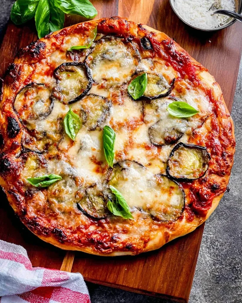 Delicious homemade pizza topped with roasted eggplant and fresh ingredients.