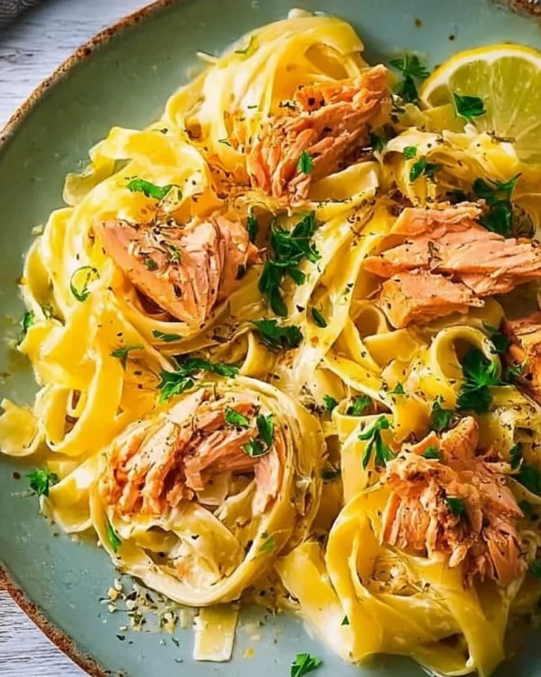 Delicious lemon pasta with salmon garnished with fresh herbs