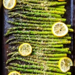 Plate of perfectly roasted asparagus drizzled with olive oil and spices