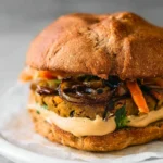 Delicious black bean veggie burger topped with fresh vegetables