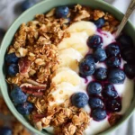 Delicious blueberry granola bowl topped with fresh berries and nuts