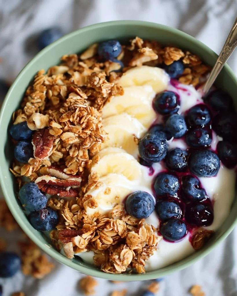 Delicious blueberry granola bowl topped with fresh berries and nuts