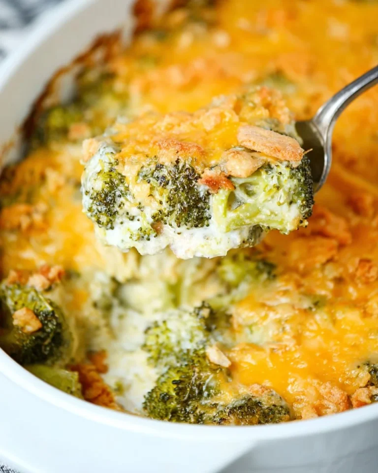 Creamy broccoli casserole topped with crunchy crackers in a baking dish.