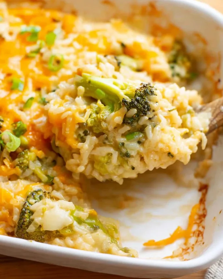 Broccoli Cheese Rice Casserole served in a baking dish with melted cheese on top.