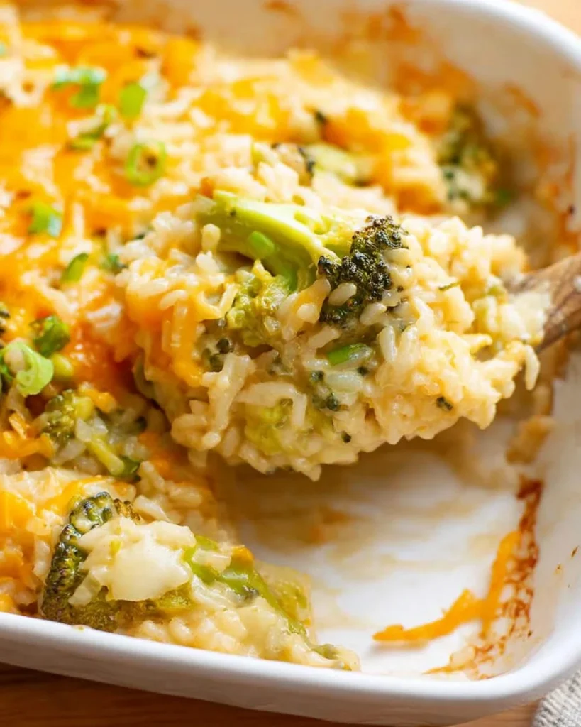 Broccoli Cheese Rice Casserole served in a baking dish with melted cheese on top.