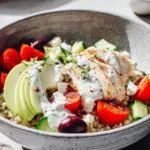 Healthy Chicken Quinoa Bowl with colorful vegetables and garnishes