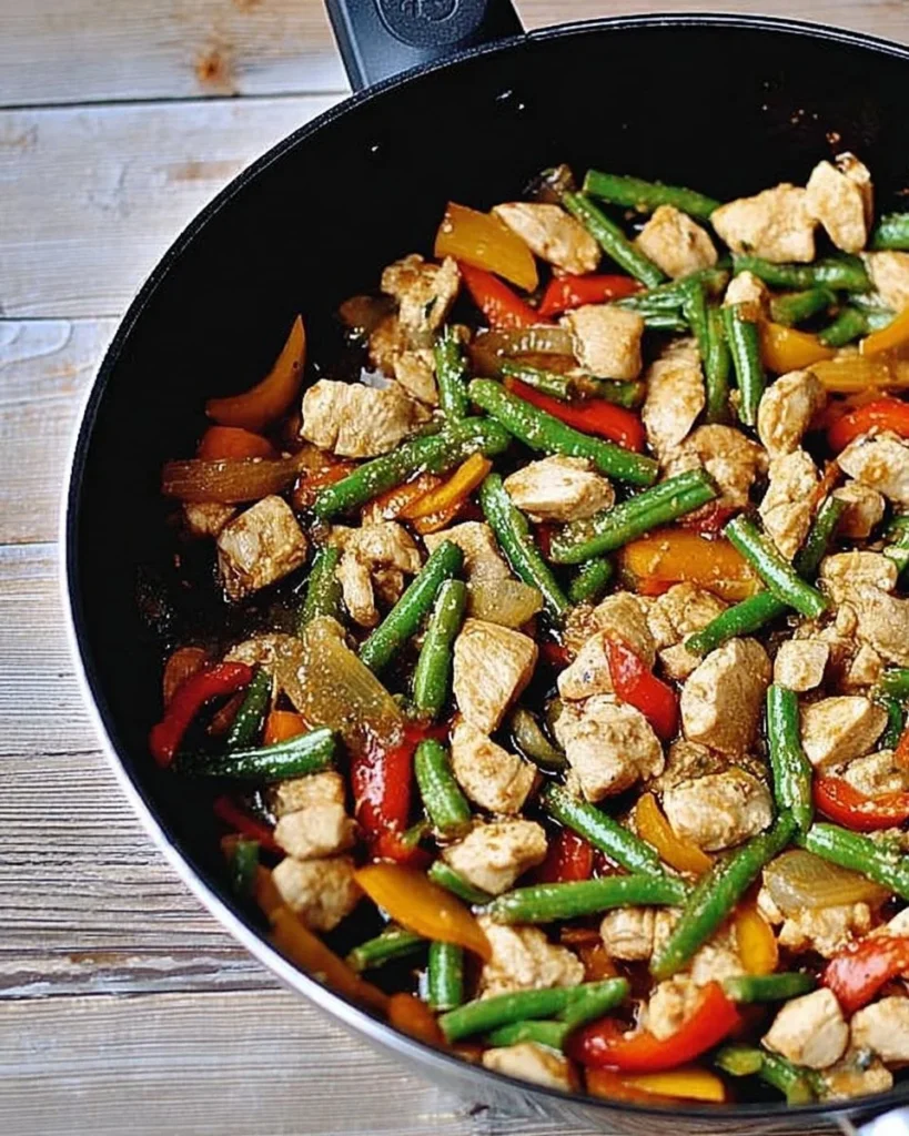 Delicious Chinese chicken stir fry with vegetables in a wok
