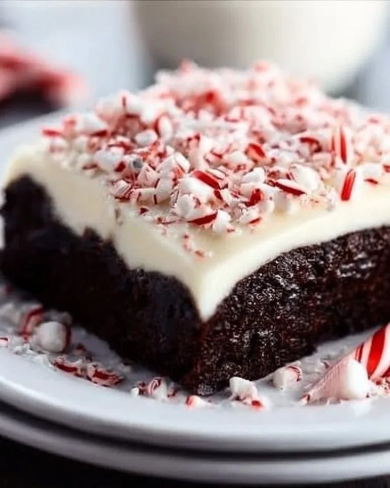 A decadent Chocolate Candy Cane Cheesecake Cake topped with festive candy canes.