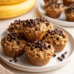 Chocolate chip banana oatmeal muffins baked in a muffin tin, golden and delicious.