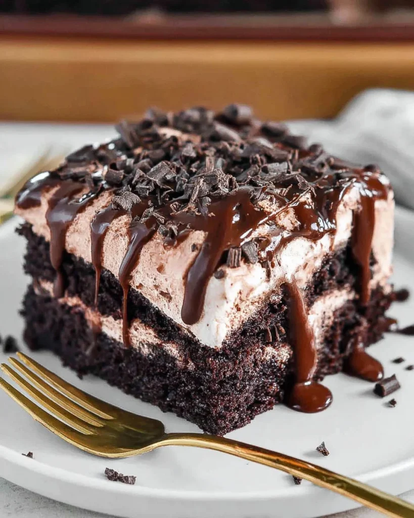 Deliciously moist Chocolate Poke Cake topped with chocolate drizzle and cream