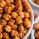 Bowl of cinnamon roasted chickpeas, a healthy crunchy snack option.