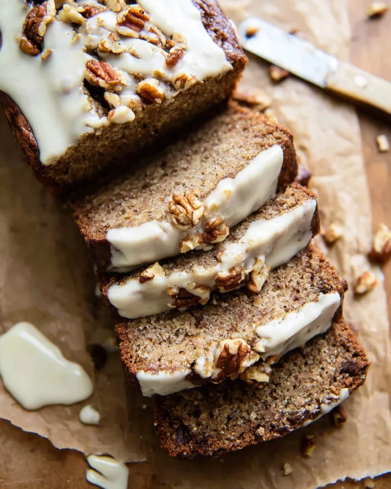 Loaf of cottage cheese banana bread with a slice cut out, showcasing its moist texture.