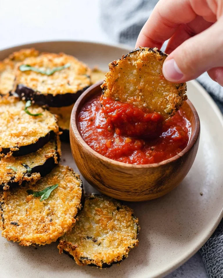 Golden crispy air fryer eggplant slices seasoned and ready to enjoy