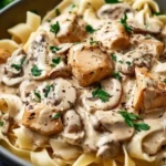 Bowl of easy creamy chicken stroganoff topped with parsley