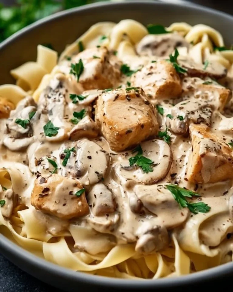 Bowl of easy creamy chicken stroganoff topped with parsley