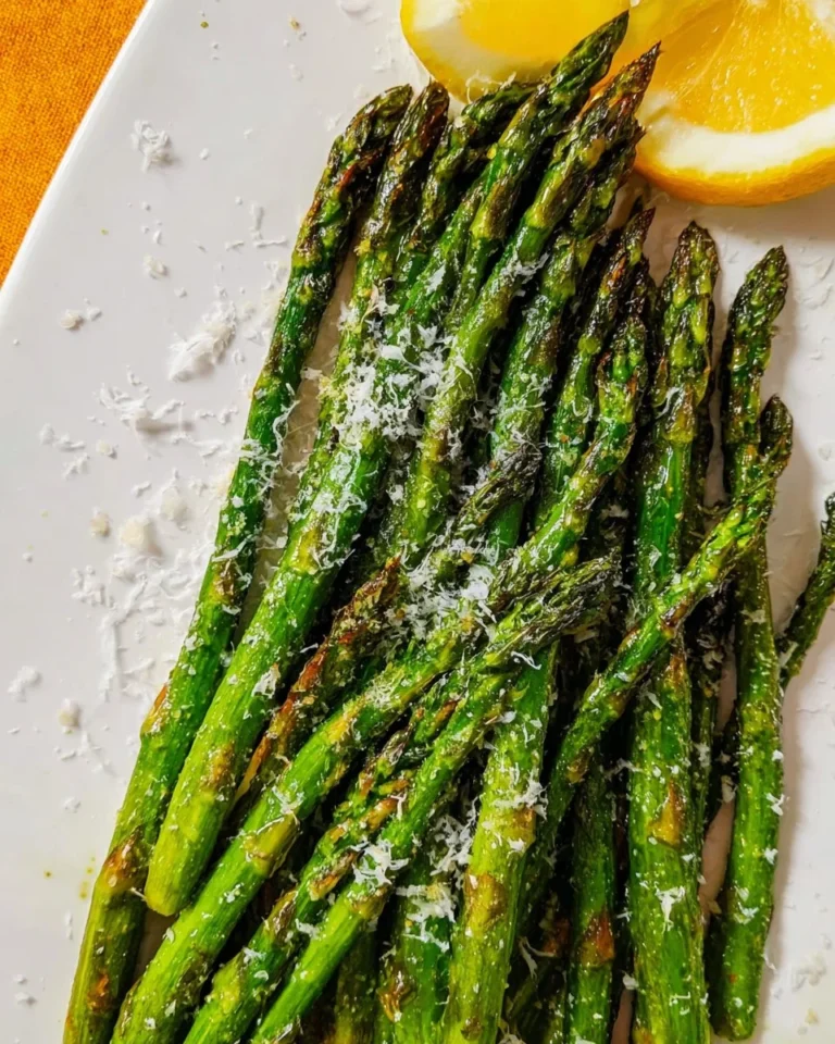 Delicious plates of easy oven roasted asparagus garnished with lemon and herbs