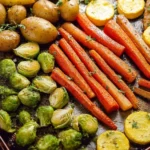 Plate of easy roasted vegetables with colorful carrots, bell peppers, and zucchini.