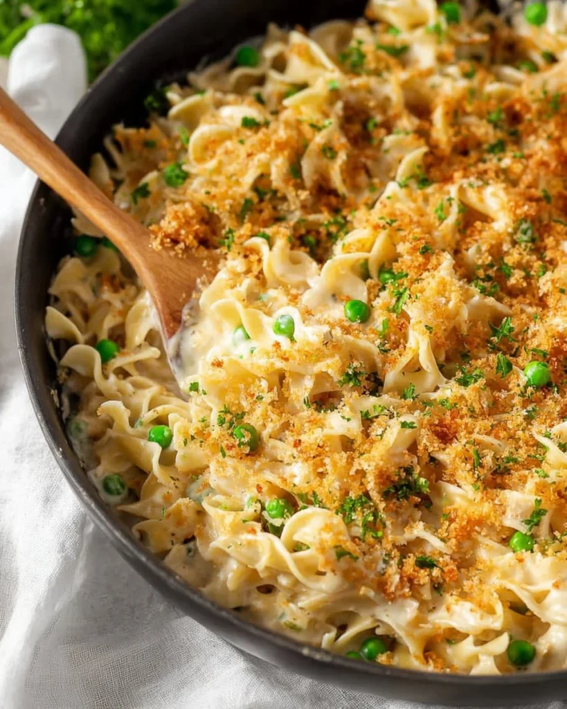 Bowl of easy tuna casserole with egg noodles topped with breadcrumbs