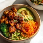 Delicious fried tofu bowls topped with fresh vegetables and sauce