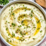 Creamy garlic butter mashed cauliflower served in a bowl.