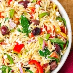 Colorful Greek orzo pasta salad with veggies and feta cheese