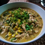 Bowl of Green Chicken Chili with fresh herbs and toppings