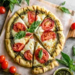Delicious grilled pesto pizza topped with fresh ingredients and melted cheese