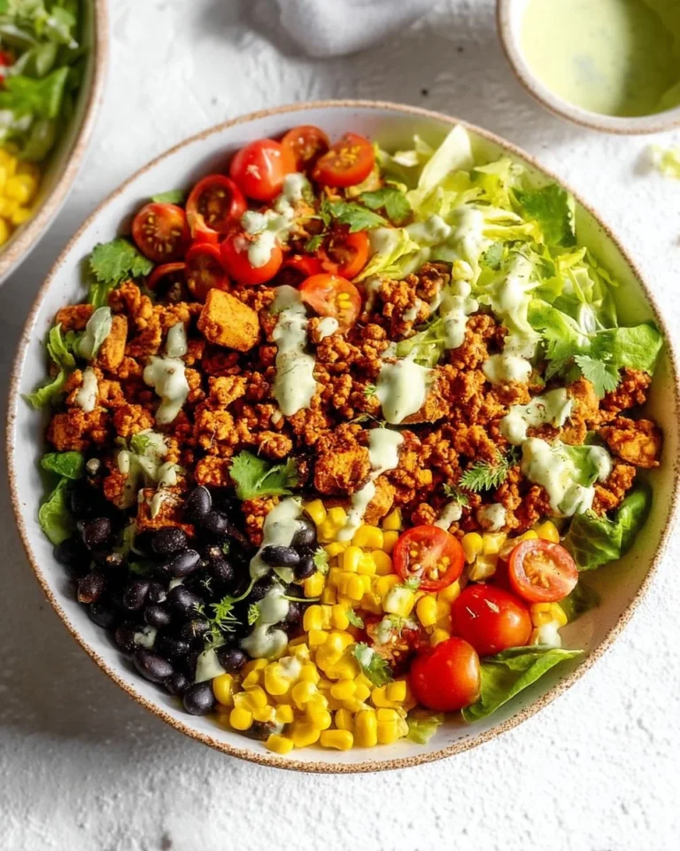 Ground turkey taco salad served in a bowl with fresh vegetables and toppings.