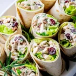 Healthy chicken salad wraps filled with fresh ingredients and served on a tortilla.