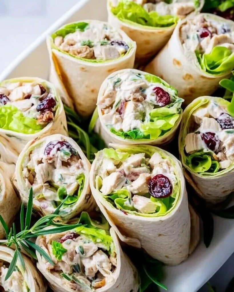 Healthy chicken salad wraps filled with fresh ingredients and served on a tortilla.