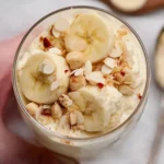 Delicious high protein banana pudding topped with fresh bananas and whipped cream