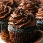 Homemade moist chocolate cupcakes topped with chocolate frosting