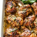 Plate of Honey Mustard Chicken garnished with herbs