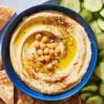 Creamy and smooth hummus recipe with chickpeas and tahini.