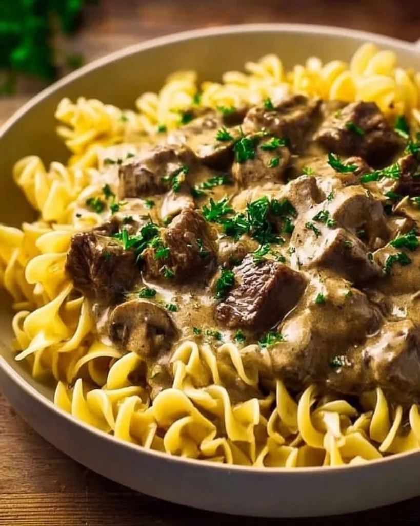 Delicious Instant Pot Beef Stroganoff served in a bowl with fresh herbs