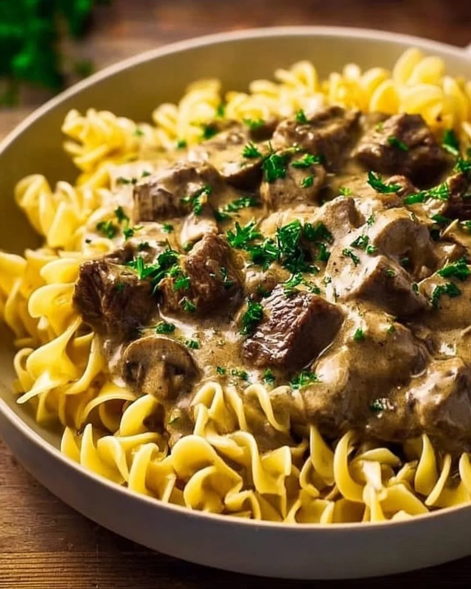 Delicious Instant Pot Beef Stroganoff served in a bowl with fresh herbs
