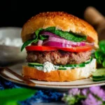 Delicious homemade lamb burger served with fresh toppings and sides