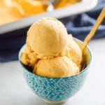Delicious bowl of Mango Ice Cream topped with fresh mango slices