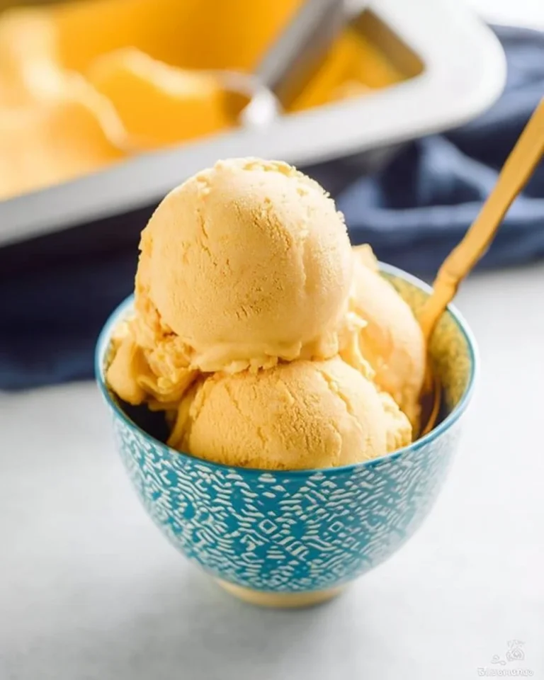 Delicious bowl of Mango Ice Cream topped with fresh mango slices