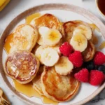 Mini banana pancakes topped with Greek yogurt and sliced bananas