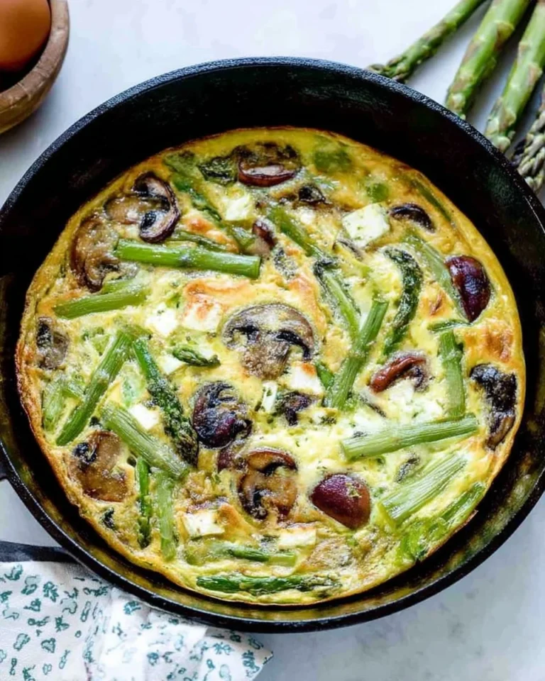 Mushroom and asparagus frittata topped with goat cheese