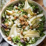 Delicious pear goat cheese salad with greens and nuts