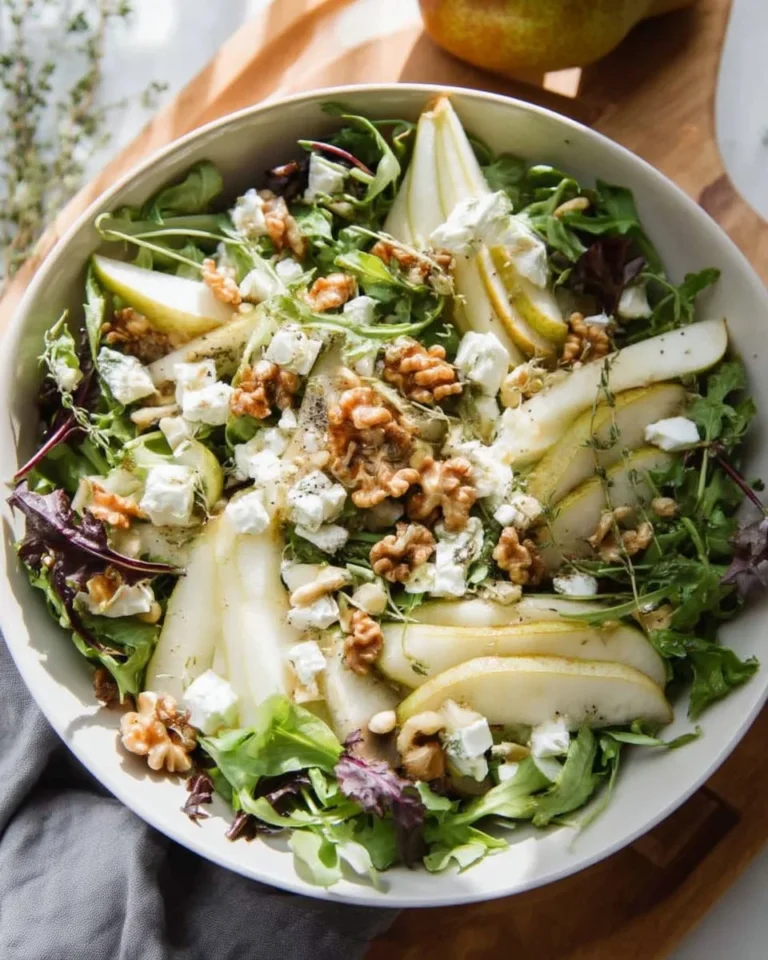 Delicious pear goat cheese salad with greens and nuts