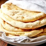 Homemade pita bread fresh out of the oven, ready to be served.