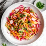 Colorful Radish Salad with fresh vegetables and herbs in a bowl.