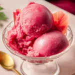 Delicious homemade rhubarb sorbet served in a bowl, garnished with mint leaves.